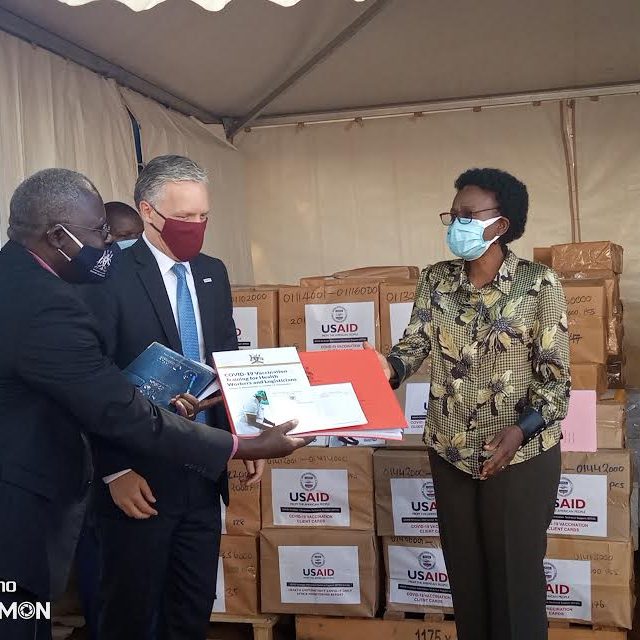 Health Minister Aceng receiving COVID-19 tools donated by USAID