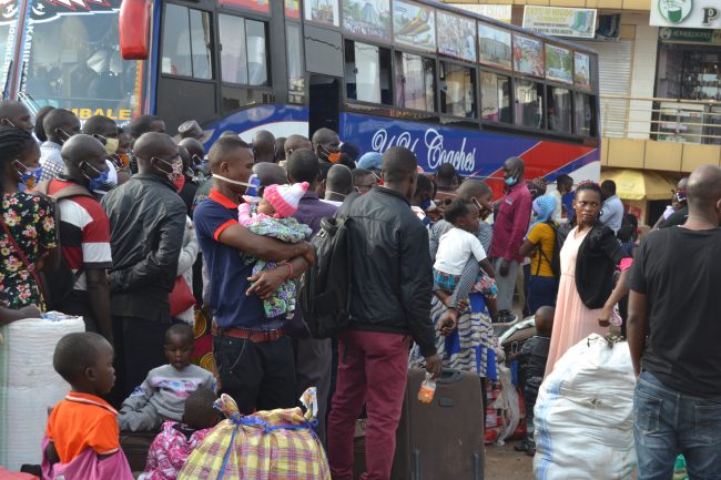 Children and adults struggling to board a bus after announcement of lockdown