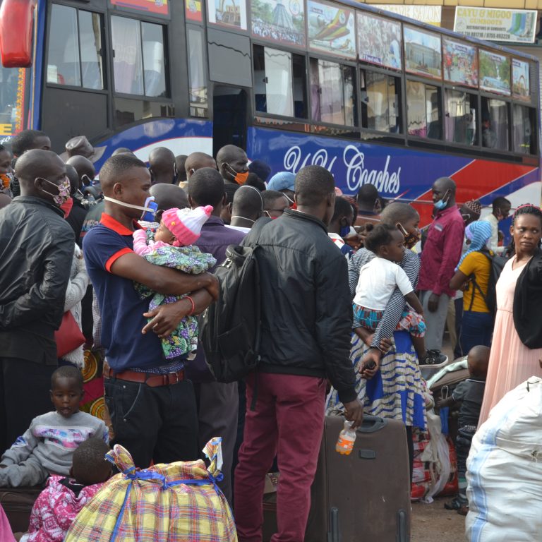 Children and adults struggling to board a bus after announcement of lockdown