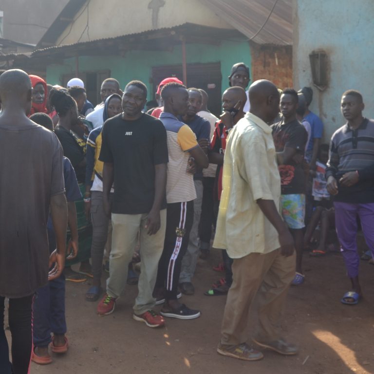 Locals gathered at the scene of Isaac Ssenyange shot dead by soldiers in December last year