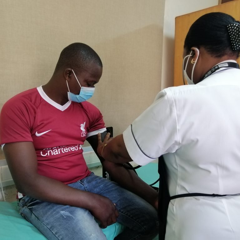 The nurse preparing one of the volunteers that is taking part in the vaccination trial before recieving the vaccine.