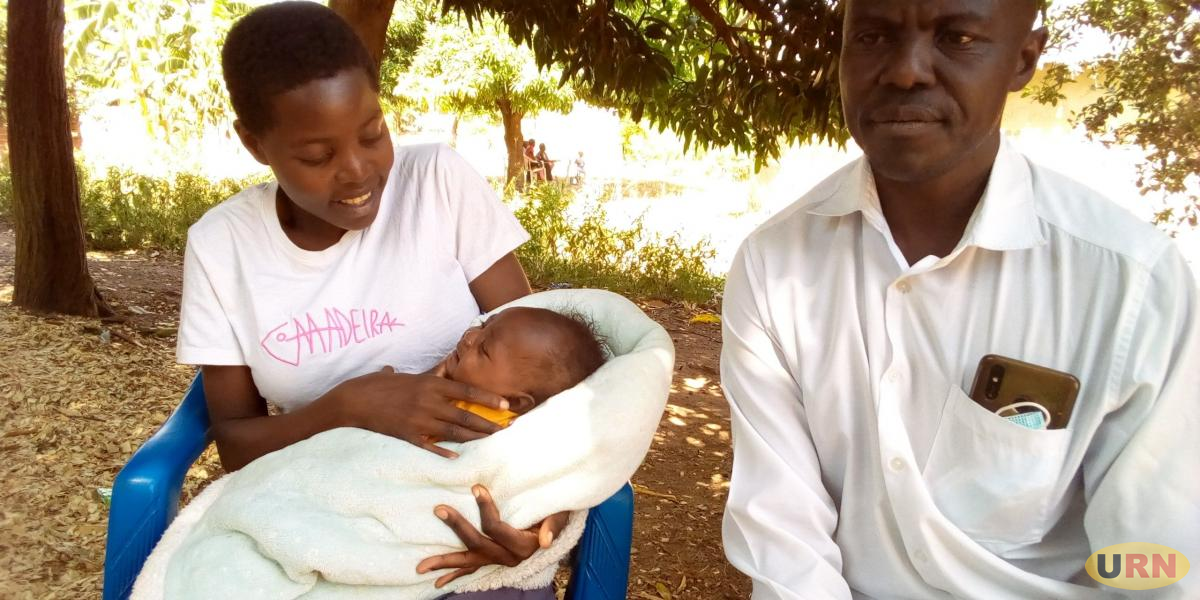 Winnie Aculo with her father, Albert Okello at the rented house where Aculo stays as she studies at Soroti SS.