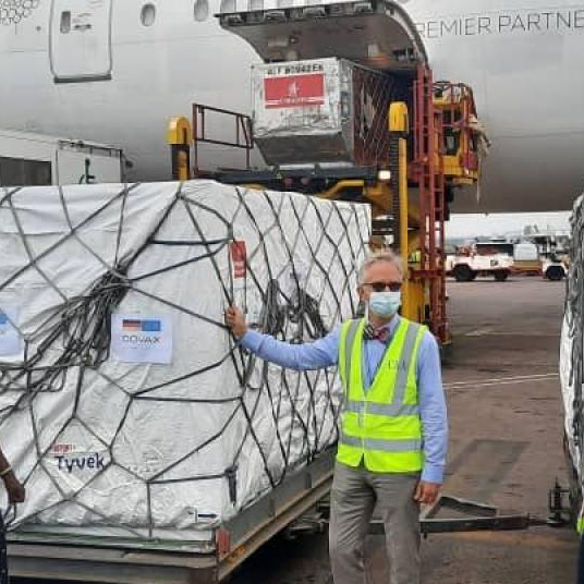 Mathias Schauer Botschatter, the German Ambassdor handing over the doses to Dr. Jane Ruth Aceng the Health Minister at Entebbe Airport
