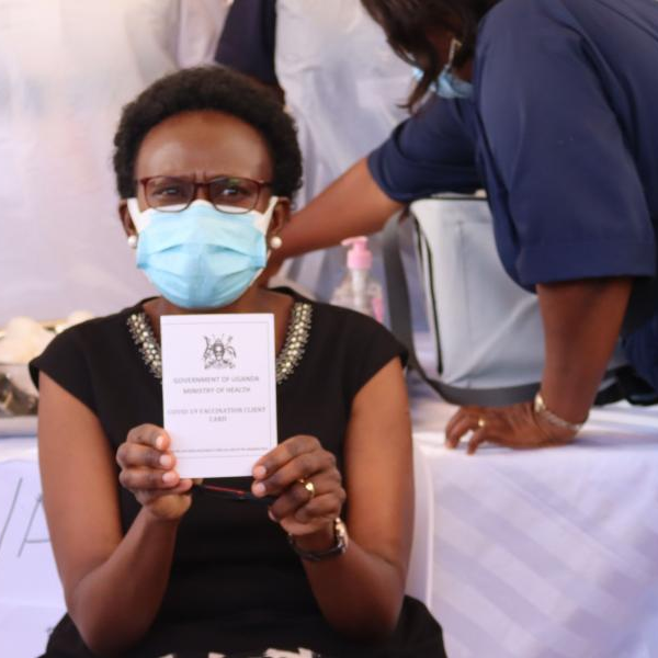 Minister of Health Jane Ruth Aceng shows off her vaccination card after receiving her first jab of the Astrazeneca Covid-19 vaccine.