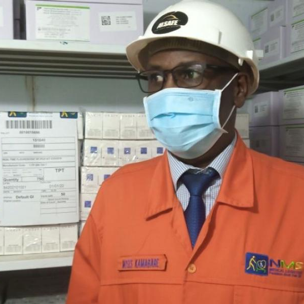 Moses Kamabre, the General Mnager Medical Stores speaks to journalists from inside the cold room for polio vaccines