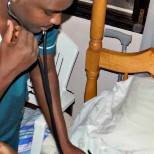 A male nurse from Tick Bedside Nursing Care with a patient